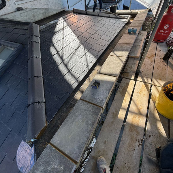 Roof construction in progress with scaffolding