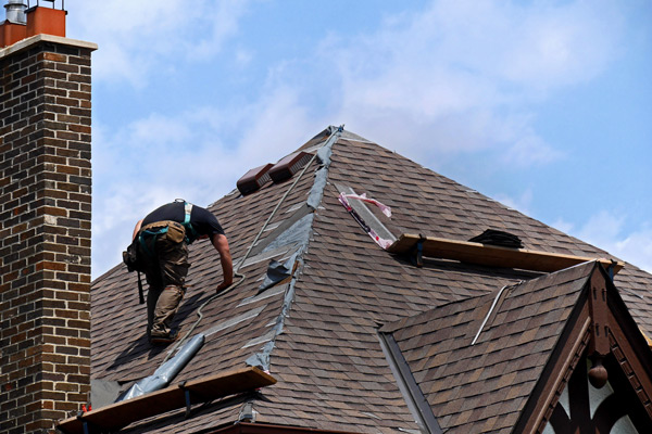 Roofer climbing up tiles in Welwyn Garden City
