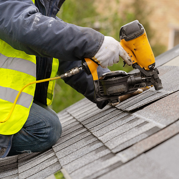 Installing new tiles on roof in Harlow